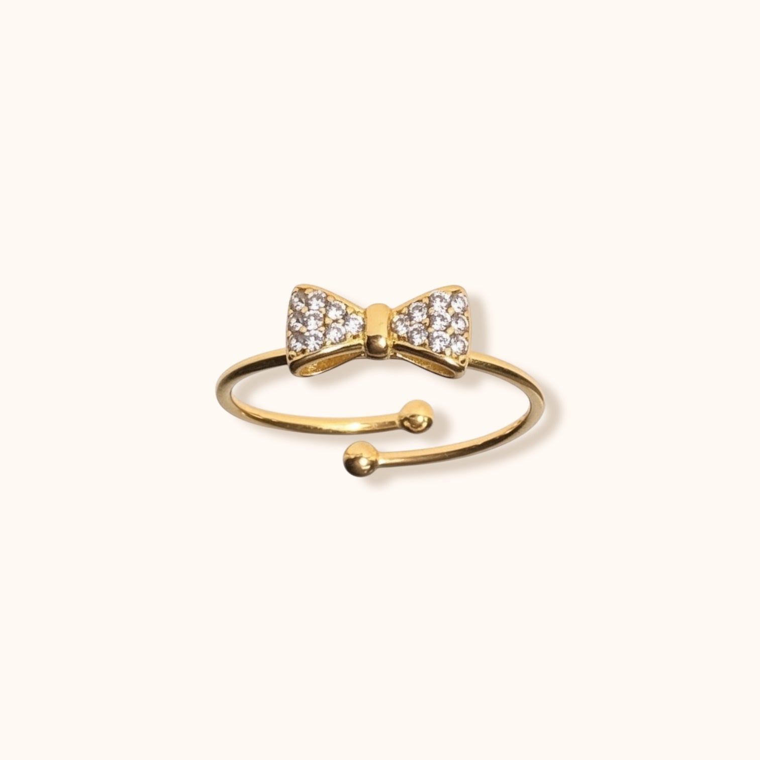 Gold-Plated Adjustable Bow Ring on Finger
Gold-plated BowLuxe adjustable ring worn on a finger, showcasing its elegant bow design and comfortable fit.
