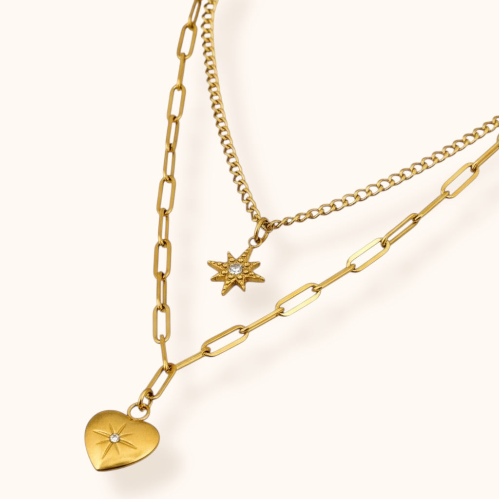 Double-layered gold necklace styled for clean-girl aesthetic featuring star and heart pendants