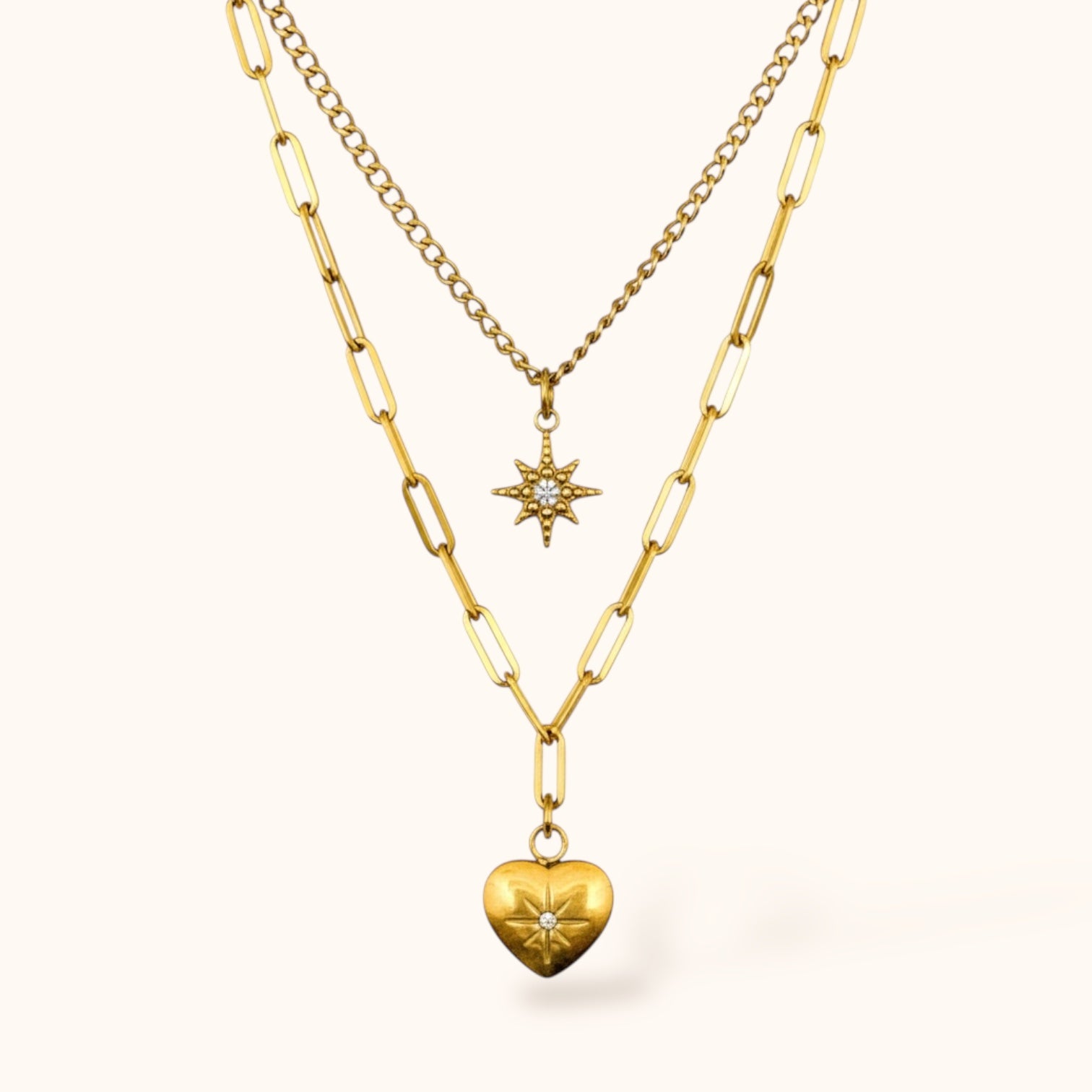 Gold-plated Celestia Necklace with double layers, shooting star pendant and heart pendant with mini zircons on neutral background