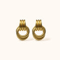 Gold-plated Entrelace Earrings with textured half triple-hoop design on neutral background