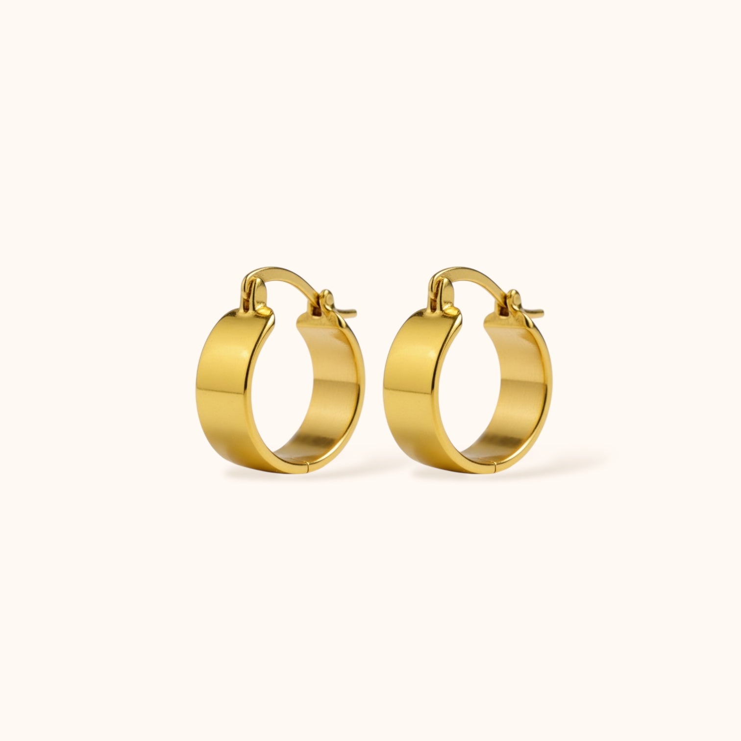 Gold-plated S925 sterling silver Mini Luxe Hoops on neutral background, small thick hoop earrings