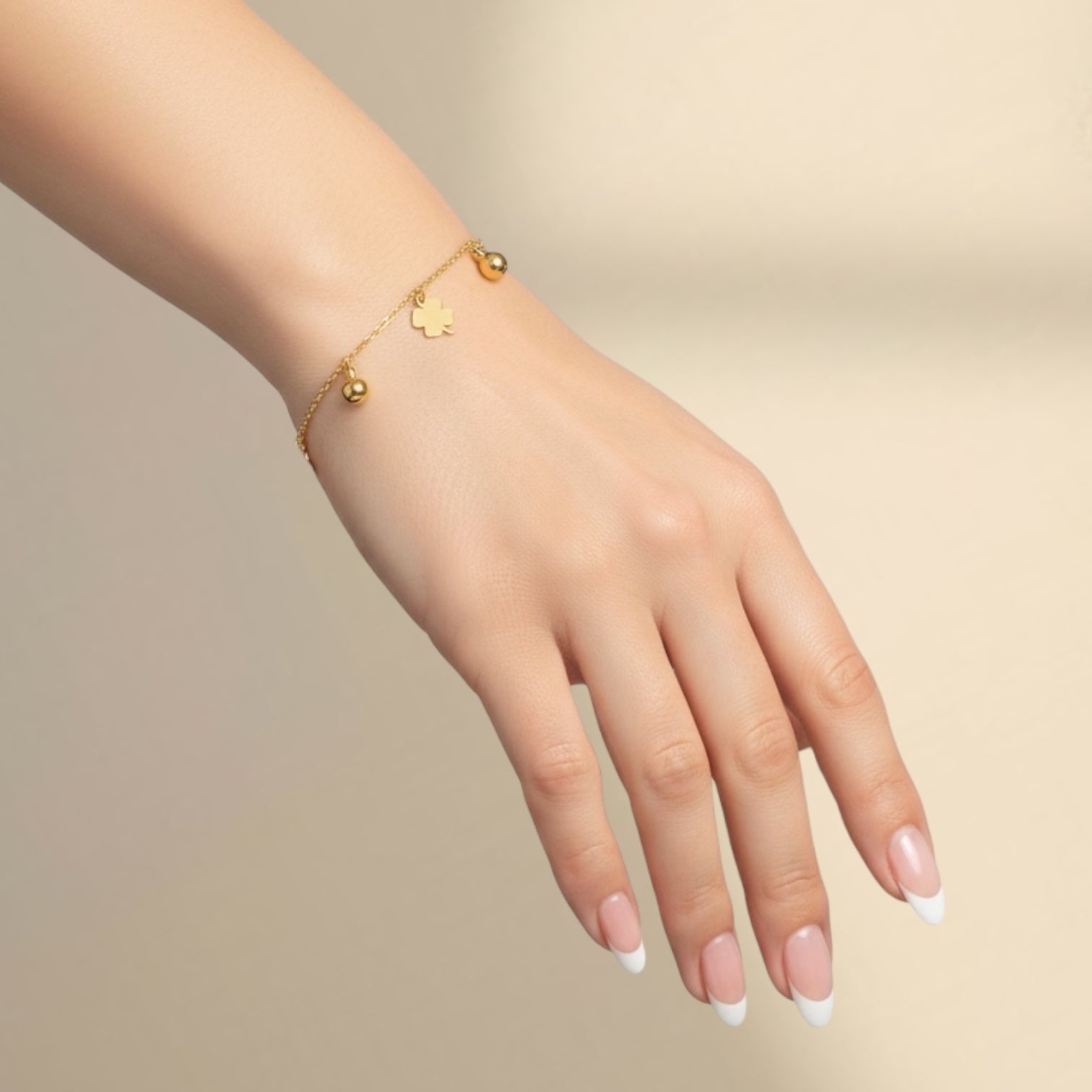Shiny gold bracelet with four-leaf clover details, perfect for a lucky charm