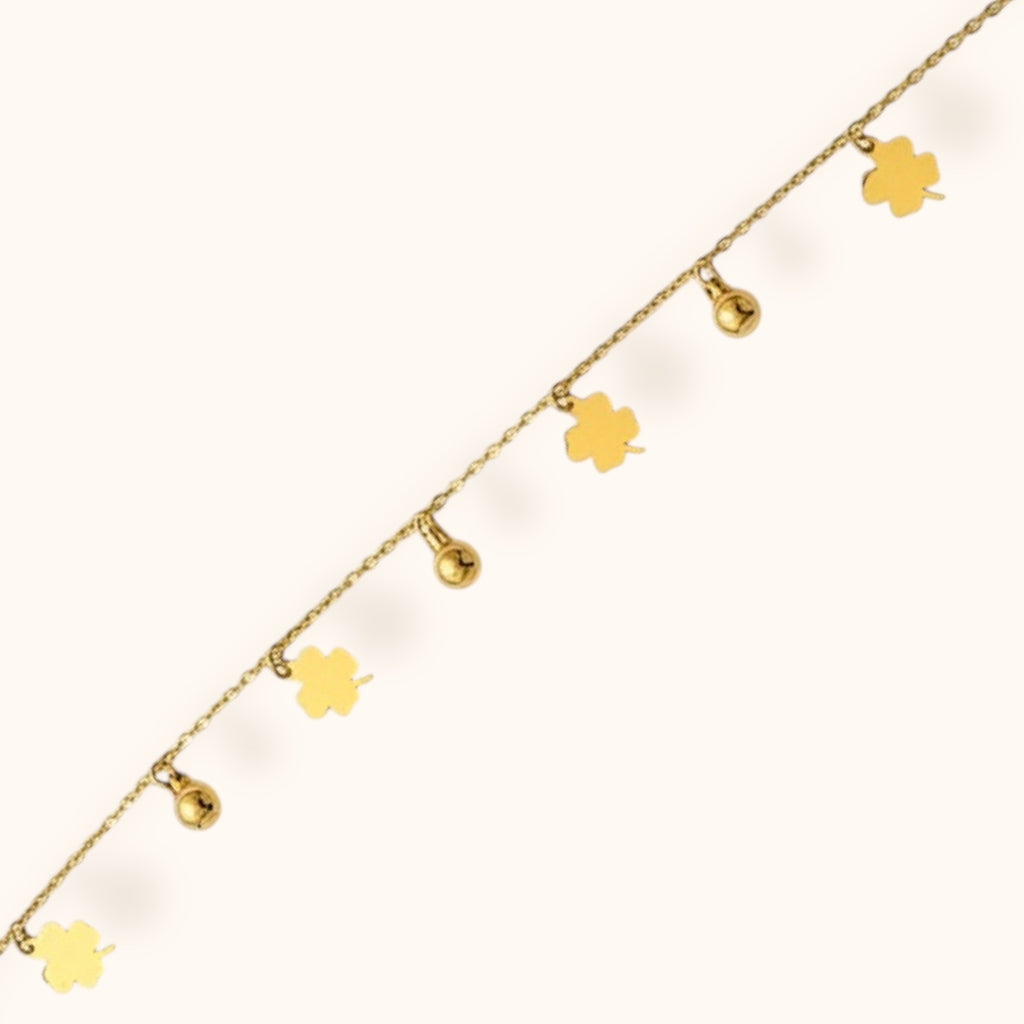 Elegant gold bracelet adorned with four-leaf clover accents for good luck