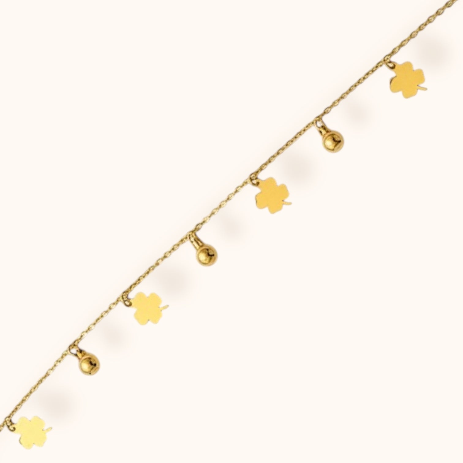 Elegant gold bracelet adorned with four-leaf clover accents for good luck