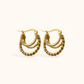 “Gold-plated layered hoop earrings with twisted center hoop”
