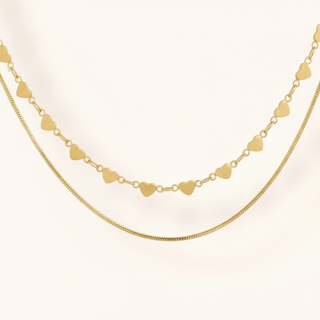Gold heart-shaped necklace on a light beige background