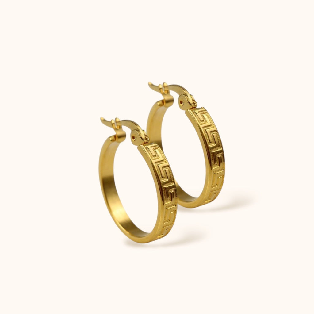 Gold patterned medium hoop earrings close-up