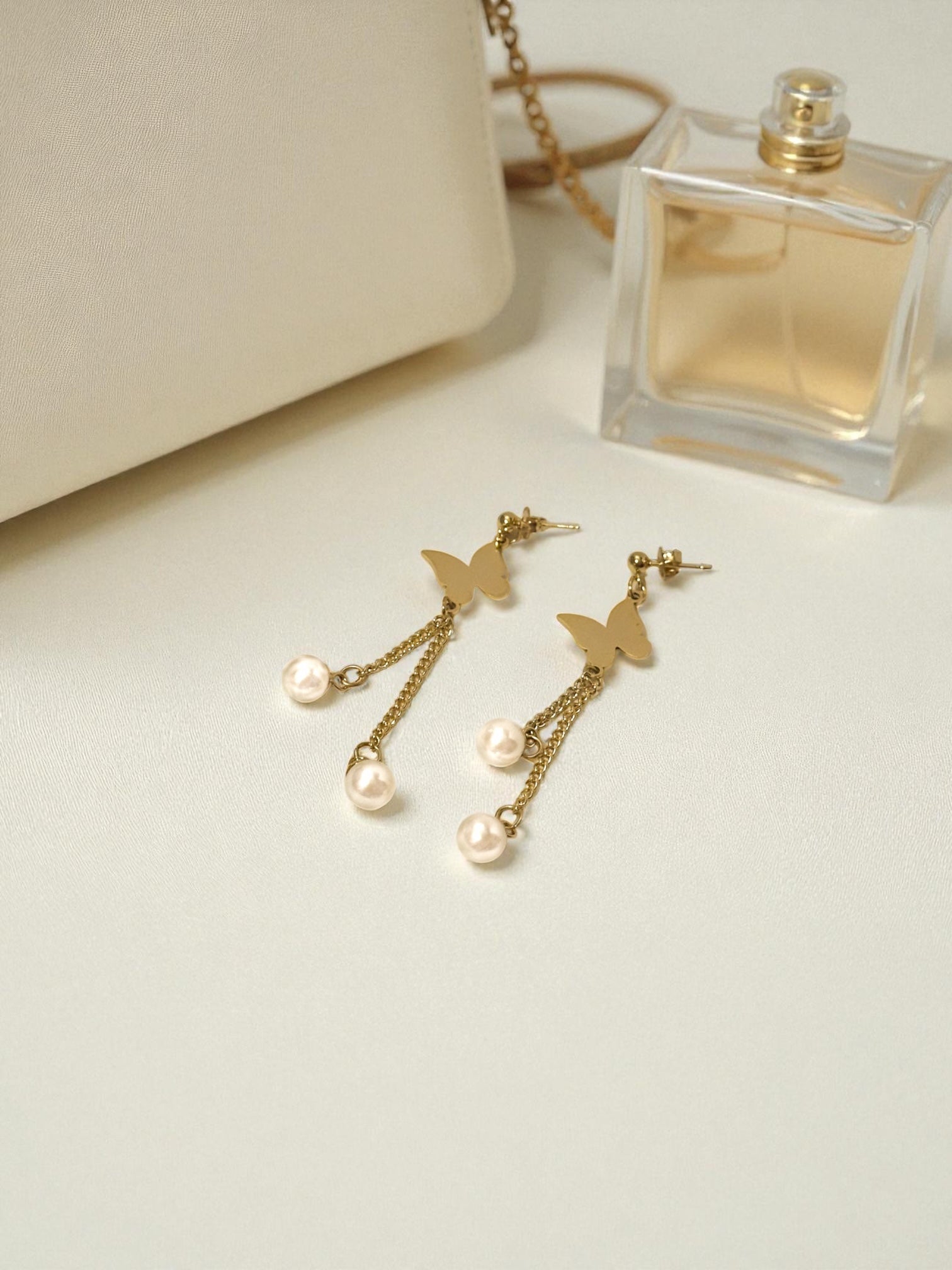 “Lightweight gold hoop earrings with delicate pearl drop accents”
