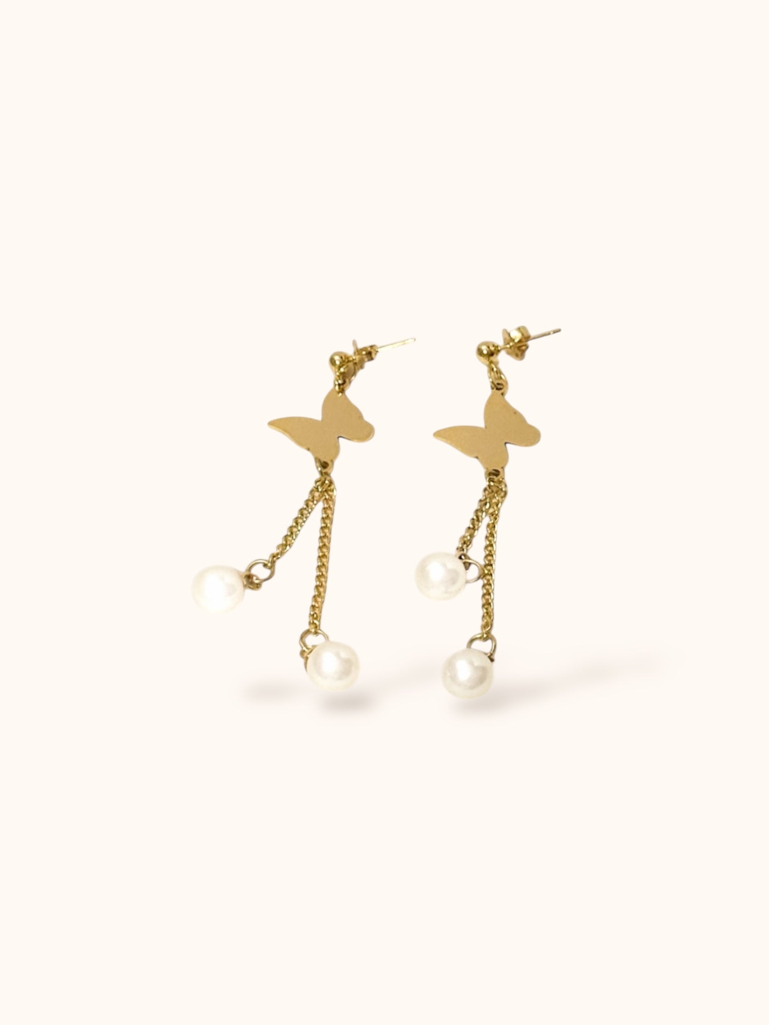 “Minimalist gold butterfly earrings with delicate pearl drops”
