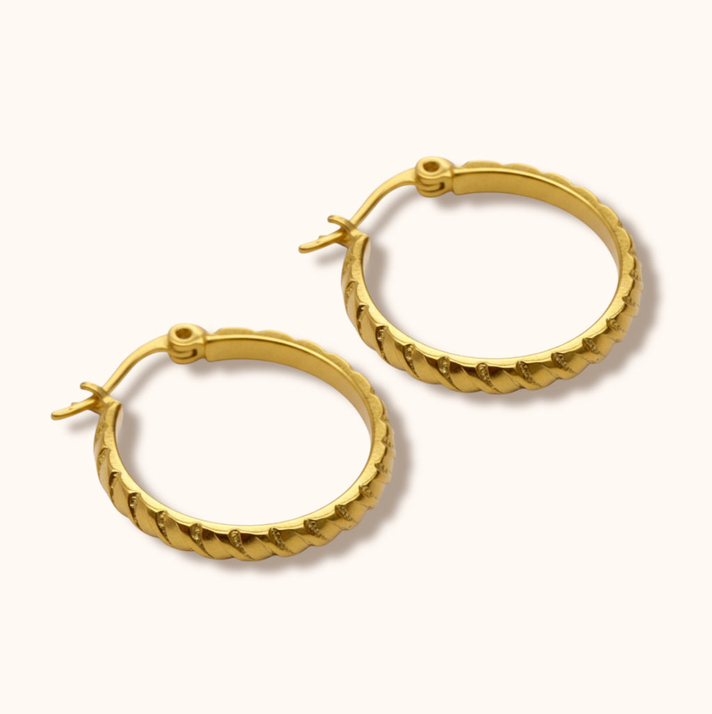 Medium gold hoop earrings with exterior line detailing