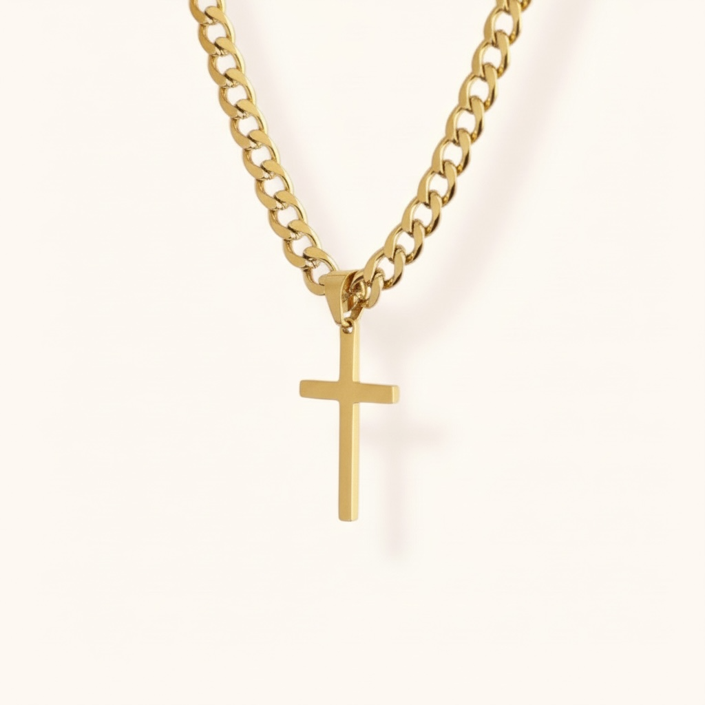Gold necklace with a cross pendant on a light background